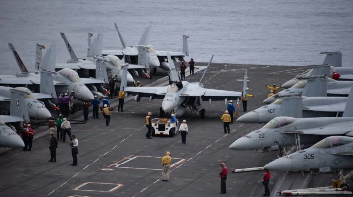 Sailors maneuver an F/A-18E Super Hornet, with Strike Fighter Squadron (VFA) 151, while preparing for flight operations on the flight deck aboard the Nimitz-class aircraft carrier USS John C. Stennis (CVN 74).