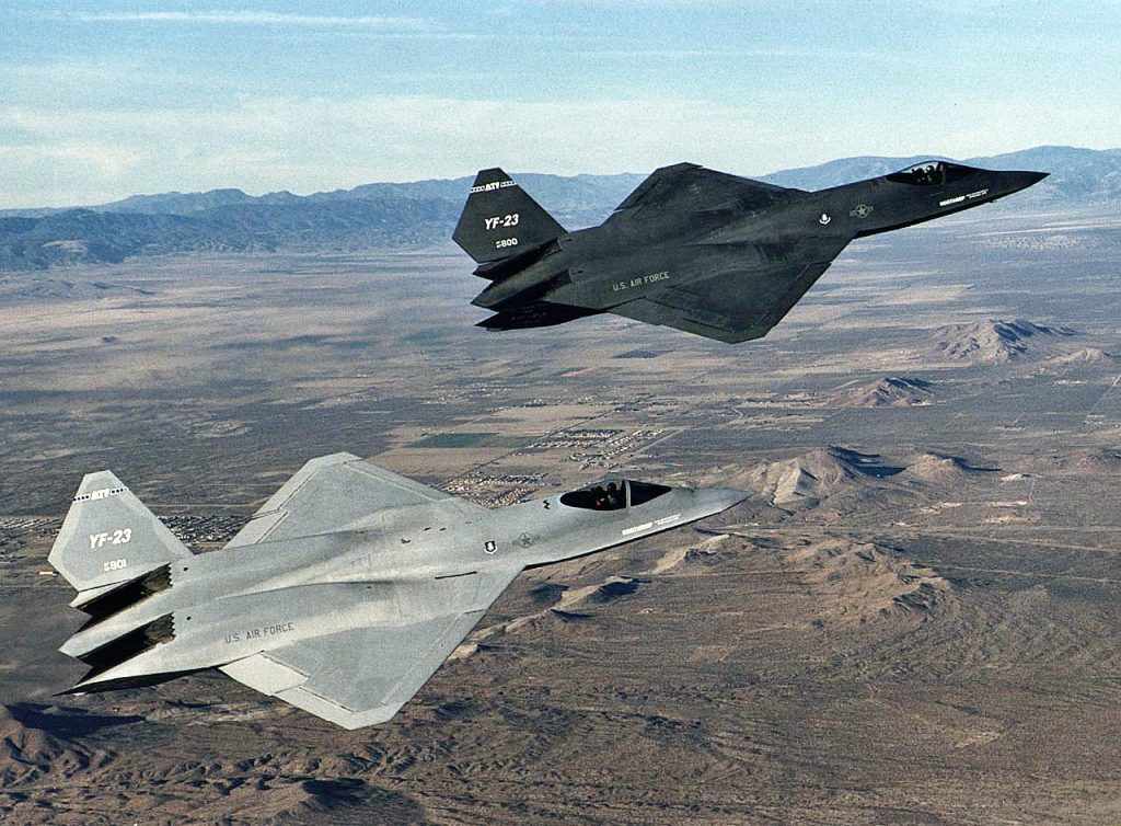 The two YF-23 prototype aircraft fly over the Mojave Desert prior to arrival at NASA's Dryden Flight Center, Edwards, California.