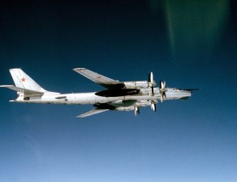 An air-to-air right side view of a Soviet Tu-95RTs Bear D strategic bomber