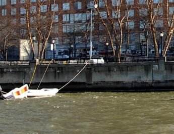 A rescue boat crew from Coast Guard Station New York enforces a security zone around a partially submerged US Airways plane in the Hudson River Jan. 16, 2009. The Coast Guard worked with the New York Police and Fire Departments and local ferry response teams to safely recover approximately 150 passengers after the airbus landed in the water.