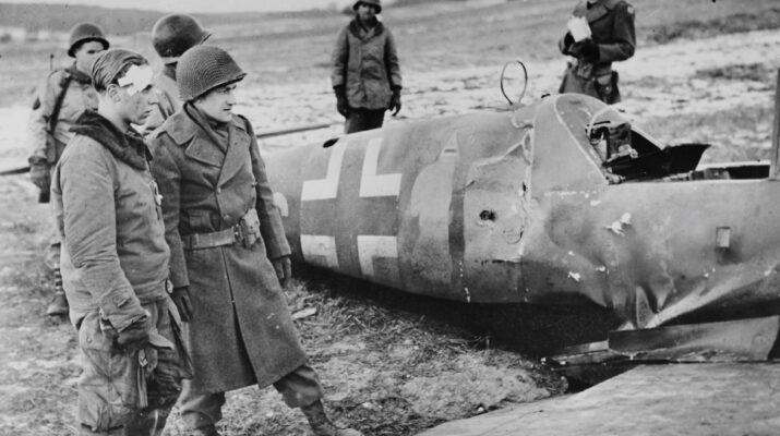 German pilot, corporal Alfred Michel from the fighter squadron JG 53, surrounded by soldiers of the 90th infantry division of the US Army by his downed Messerschmitt Bf.109 G-14. The plane was shot down in the commune Waldweisdorf, 1944. This was Michel's first and last combat sortie.